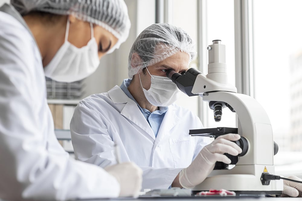 close-up-scientist-working-with-microscope