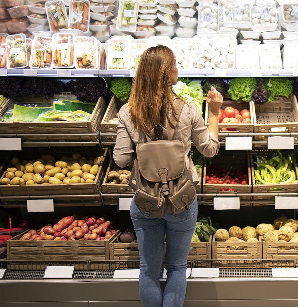 good-looking-woman-standing-front-vegetable-shelves-choosing-what-buy