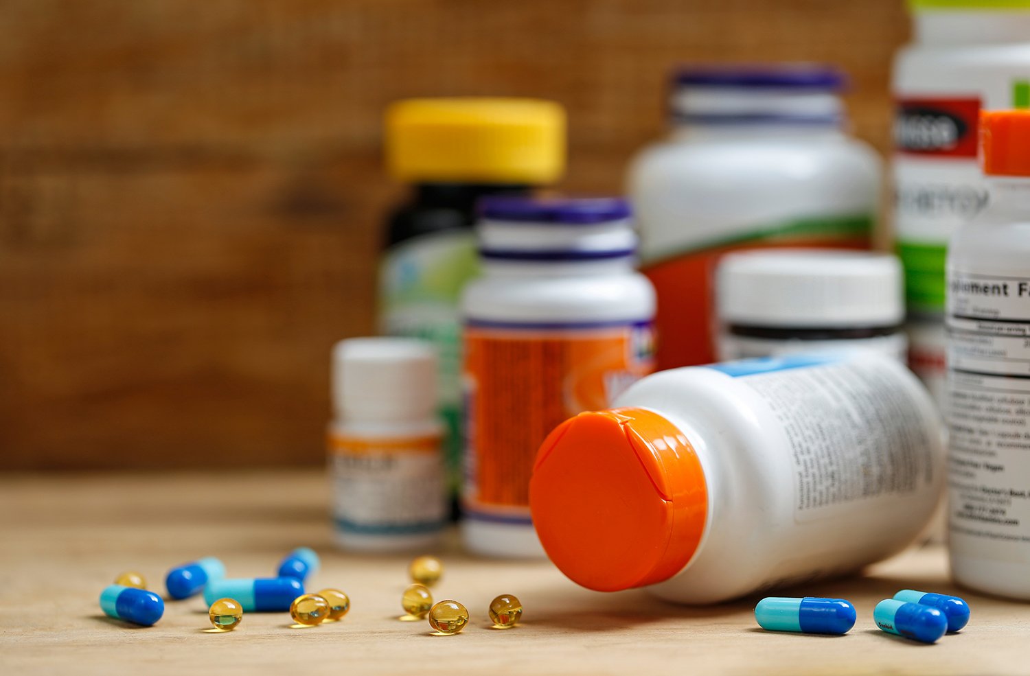 medicine-bottles-tablets-wooden-desk