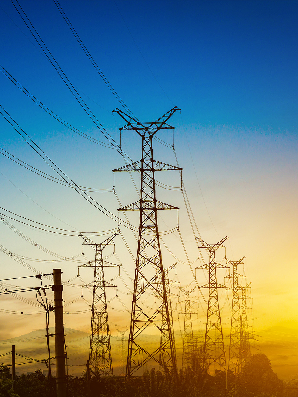 sun-setting-silhouette-electricity-pylons