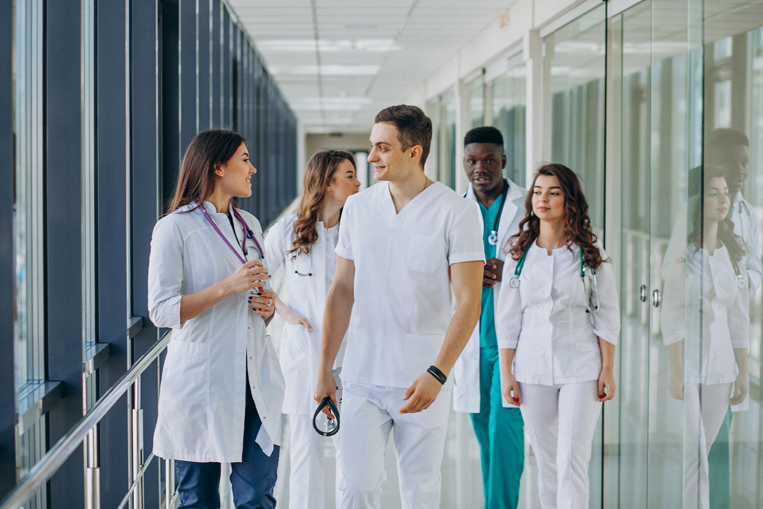 team-of-young-specialist-doctors-standing-in-the-corridor-of-the-hospital