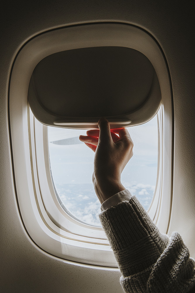 woman-opening-window-shade