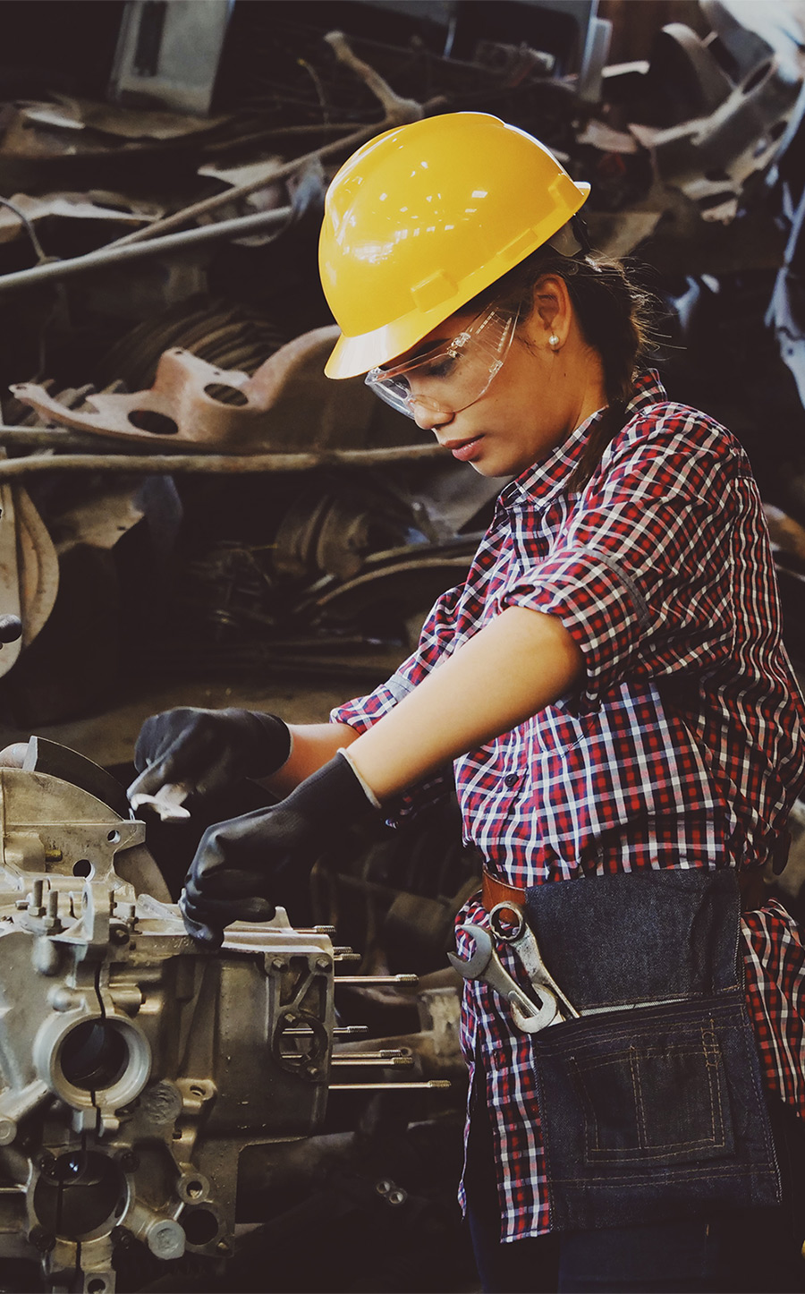 woman-wears-yellow-hard-hat-holding-vehicle-part-1108101