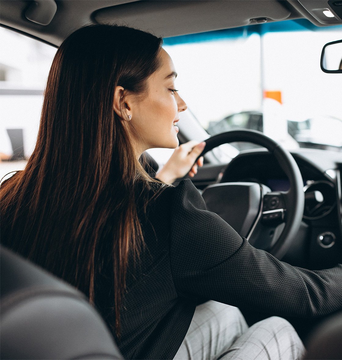 young-woman-testing-car-car-showroom